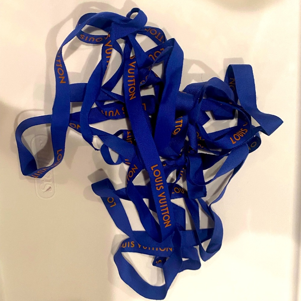 Clump of authentic Louis Vuitton blue ribbon with dark yellow writing